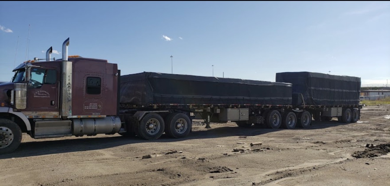 Super B-train flatbed configuration with black-tarped freight